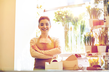 Image showing smiling florist woman at flower shop cashbox