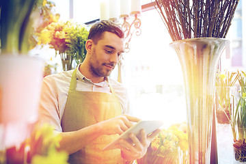 Image showing man with tablet pc computer at flower shop