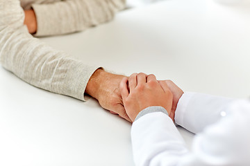 Image showing close up of doctor holding old man hand