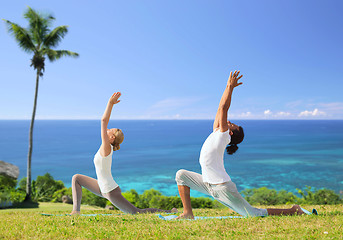 Image showing couple making yoga in low lunge pose outdoors