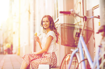 Image showing happy woman with bike and ice cream