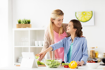 Image showing family cooking dinner using tablet pc at kitchen