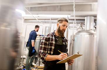 Image showing men with clipboard at craft brewery or beer plant