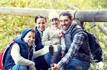 Image showing happy family with smartphone selfie stick in woods