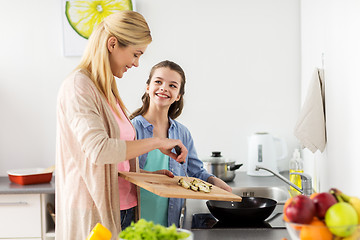Image showing happy family cooking food at home kitchen