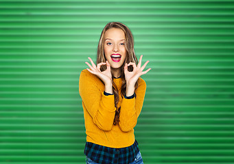 Image showing happy young woman or teen showing ok hand sign