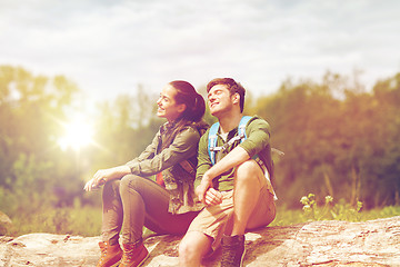 Image showing smiling couple with backpacks in nature