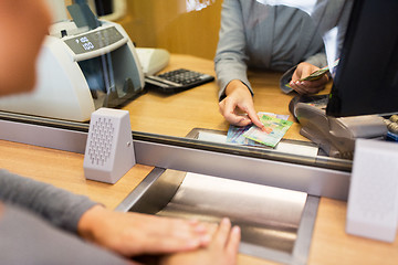 Image showing clerk counting cash money at bank office