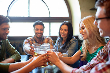 Image showing happy friends drinking beer at bar or pub