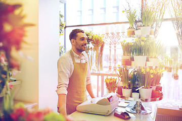 Image showing florist man or seller at flower shop counter