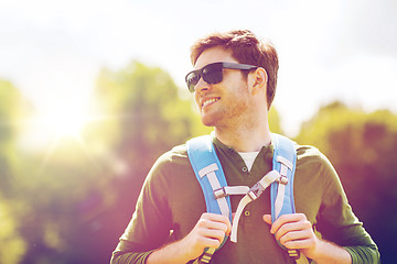 Image showing happy young man with backpack hiking outdoors