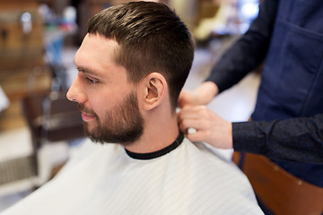 Image showing hairdresser and man with beard at barbershop