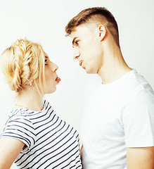 Image showing young pretty teenage couple, hipster guy with his girlfriend happy smiling and hugging isolated on white background, lifestyle people concept