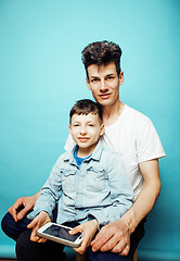 Image showing young pretty man model with little cute son playing together, lifestyle modern people concept, family male 