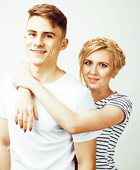 Image showing young pretty teenage couple, hipster guy with his girlfriend happy smiling and hugging isolated on white background, lifestyle people concept