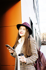 Image showing young pretty hipster girl student with coffee cup posing adorable smiling, lifestyle people concept outdoor