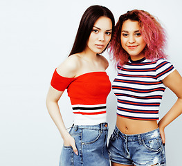 Image showing lifestyle people concept: two pretty stylish modern hipster teen girl having fun together, diverse nation mixed races, happy smiling making selfie