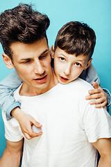 Image showing young pretty man model with little cute son playing together, lifestyle modern people concept, family male 