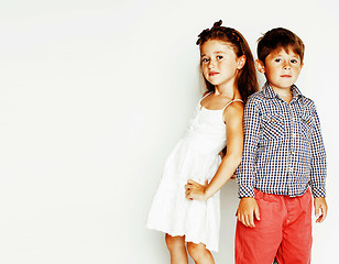 Image showing little cute boy and girl hugging playing on white background, ha