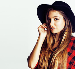 Image showing young pretty brunette girl hipster in hat on white background casual close up dreaming smiling