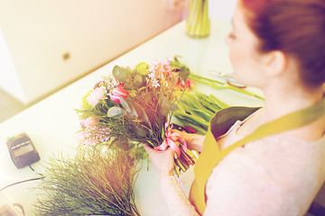 Image showing close up of woman making bunch at flower shop