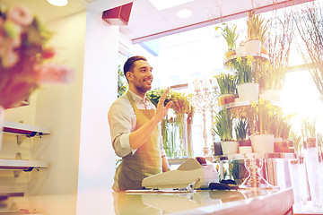 Image showing florist man or seller at flower shop counter