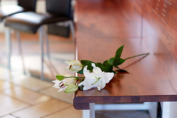 Image showing white lily on bench at funeral in church