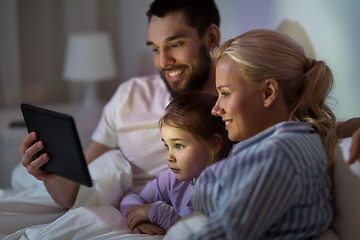 Image showing happy family with tablet pc in bed at home