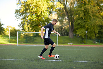 Image showing soccer player playing with ball on football field