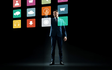 Image showing businessman in suit touching virtual menu icons