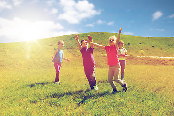 Image showing group of happy kids running outdoors