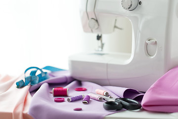 Image showing sewing machine, scissors, buttons and fabric