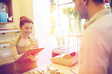 Image showing florist woman and man making order at flower shop