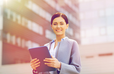 Image showing smiling business woman with tablet pc in city