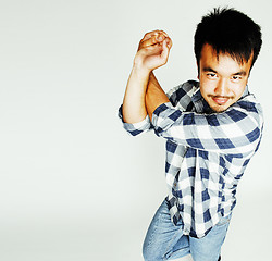 Image showing young cute asian man on white background gesturing emotional, po