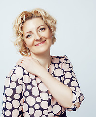 Image showing mature blond curly woman cheerful posing on white background isolated, lifestyle people concept