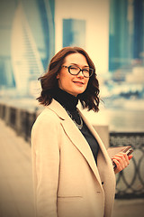 Image showing fashion style. portrait of a beautiful businesswoman in a light 