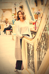 Image showing Smiling woman in a knitted bright summer coat