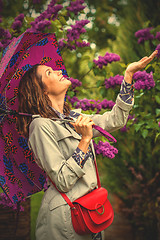 Image showing smiling middle-aged woman with an umbrella 