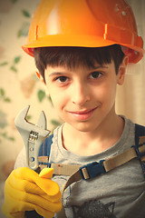 Image showing Boy in a protective helmet and with a wrenc