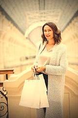 Image showing woman with packages in city shopping center