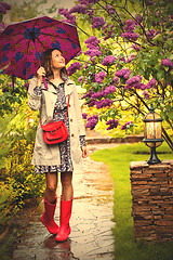 Image showing Beautiful woman with an umbrella on a rainy day