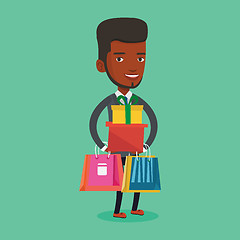 Image showing Happy man holding shopping bags and gift boxes.