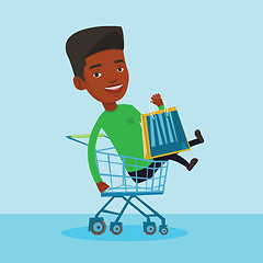 Image showing Happy man riding by shopping trolley.