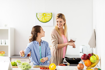 Image showing happy family cooking salad at home kitchen