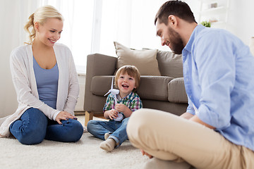 Image showing happy family playing with toy wind turbine