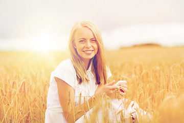 Image showing happy woman with smartphone and earphones