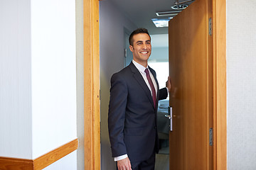 Image showing businessman at hotel room or office door