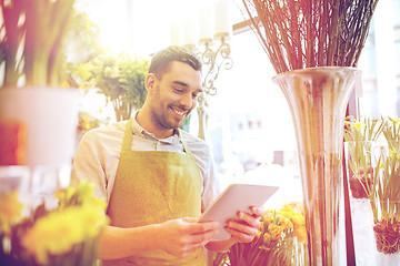 Image showing man with tablet pc computer at flower shop