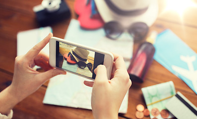 Image showing close up of woman with smartphone and travel stuff